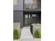 The front entryway showcases sleek brickwork, a modern door, and minimalist landscaping at 928 Cimarron Dr # C, Lafayette, CO 80026