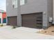 Attached garages with modern doors and sleek design at 928 Cimarron Dr # C, Lafayette, CO 80026
