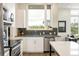 Modern kitchen with stainless steel appliances, grey countertops, and large window with a view at 928 Cimarron Dr # C, Lafayette, CO 80026