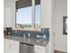 Bright kitchen with modern tile backsplash, stainless steel appliances, and scenic view at 928 Cimarron Dr # C, Lafayette, CO 80026