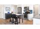 Kitchen dining area featuring stainless steel appliances, a breakfast bar, and ample cabinet space at 928 Cimarron Dr # C, Lafayette, CO 80026