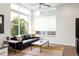 Open living room featuring modern furniture, a ceiling fan and large windows offering an abundance of natural light at 928 Cimarron Dr # C, Lafayette, CO 80026