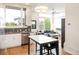 Open-concept living space with large windows, modern furnishings, and a connected kitchen area at 928 Cimarron Dr # C, Lafayette, CO 80026