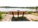 Scenic view of a wood park bench near a tranquil lake, perfect for enjoying nature at 928 Cimarron Dr # C, Lafayette, CO 80026