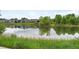 Scenic pond reflecting the surrounding landscape and neighborhood homes at 928 Cimarron Dr # C, Lafayette, CO 80026