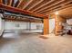 Unfinished basement with exposed beams, a fire extinguisher, and large open area at 7254 S Kellerman Way, Aurora, CO 80016