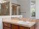 Bathroom with modern vanity, mirror, and glass enclosed shower, offering a clean and functional design at 7254 S Kellerman Way, Aurora, CO 80016