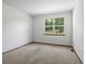 Bright bedroom features a large window, neutral carpet, and fresh paint at 7254 S Kellerman Way, Aurora, CO 80016