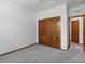 Bedroom with light-colored carpet, closet, and natural wood door and trim at 7254 S Kellerman Way, Aurora, CO 80016