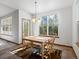 Bright dining area featuring a wooden table, large windows, and colorful rug at 7254 S Kellerman Way, Aurora, CO 80016