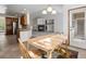Bright dining area next to kitchen and living room featuring a wooden table and colorful rug at 7254 S Kellerman Way, Aurora, CO 80016