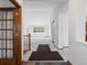 Bright entryway with hardwood floors transitioning into plush carpeting, offering a welcoming space at 7254 S Kellerman Way, Aurora, CO 80016