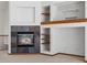 Close-up of a fireplace with stone surround and built-in shelving at 7254 S Kellerman Way, Aurora, CO 80016