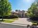 Charming two-story home featuring stone accents, dormer windows, and a welcoming front porch at 7254 S Kellerman Way, Aurora, CO 80016