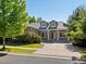 Charming two-story home featuring stone accents, dormer windows, and a welcoming front porch at 7254 S Kellerman Way, Aurora, CO 80016