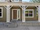 Inviting front porch with decorative pillars and clear house number for easy identification at 7254 S Kellerman Way, Aurora, CO 80016