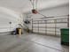 Spacious garage with a garage door, storage shelves, and ample room for vehicles at 7254 S Kellerman Way, Aurora, CO 80016