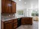 Kitchen island with granite counters and stainless steel dishwasher at 7254 S Kellerman Way, Aurora, CO 80016