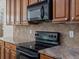 Close up of the kitchen showing stainless steel range and microwave at 7254 S Kellerman Way, Aurora, CO 80016