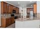 Kitchen with granite counters, wood cabinets, and modern appliances at 7254 S Kellerman Way, Aurora, CO 80016
