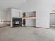 Cozy living room featuring a fireplace, built-in shelving, and neutral carpet at 7254 S Kellerman Way, Aurora, CO 80016