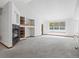 Bright living room featuring a cozy fireplace, built-in shelving, and a large window for ample natural light at 7254 S Kellerman Way, Aurora, CO 80016