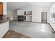 Open-concept living room featuring a fireplace, built-in shelves, and easy access to the kitchen at 7254 S Kellerman Way, Aurora, CO 80016