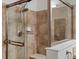 Detailed shot of a glass-enclosed shower stall with a rainfall showerhead and tile surround at 7254 S Kellerman Way, Aurora, CO 80016