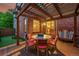 A wooden backyard deck featuring an outdoor dining table and a view of the putting green at 7064 E 2Nd Ave, Denver, CO 80220