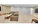 Finished basement featuring neutral carpet, sofa, and panelled wall at 7064 E 2Nd Ave, Denver, CO 80220