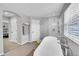 Bright bathroom featuring a soaking tub and glass shower with white subway tile at 7064 E 2Nd Ave, Denver, CO 80220