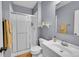 Bathroom featuring a glass shower, modern vanity, and neutral color scheme at 7064 E 2Nd Ave, Denver, CO 80220