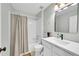 Bathroom with tub and shower combination with light blue walls and white vanity at 7064 E 2Nd Ave, Denver, CO 80220
