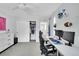 Bedroom with dual monitors on a desk and an open closet with clothes displayed at 7064 E 2Nd Ave, Denver, CO 80220