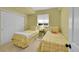 Charming bedroom featuring two twin beds, a window, and neutral decor at 7064 E 2Nd Ave, Denver, CO 80220