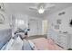 Bedroom with grey tufted headboard and vanity with decorative accents at 7064 E 2Nd Ave, Denver, CO 80220