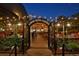 Evening view of the Lowry Beer Garden entrance with string lights, open seating, and festive atmosphere at 7064 E 2Nd Ave, Denver, CO 80220