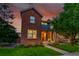 Charming brick home with landscaped front yard, and an inviting covered porch, perfect for enjoying the sunset at 7064 E 2Nd Ave, Denver, CO 80220