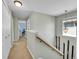 Second floor hallway featuring neutral walls and vintage ski decor at 7064 E 2Nd Ave, Denver, CO 80220