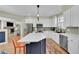 Stylish kitchen with a functional island, stainless appliances, and open access to the cozy living area at 7064 E 2Nd Ave, Denver, CO 80220