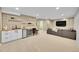 Bright living room featuring a wet bar, sofa, recessed lighting, and access to another room at 7064 E 2Nd Ave, Denver, CO 80220