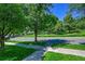 Nice street view with trees and a sidewalk at 7064 E 2Nd Ave, Denver, CO 80220