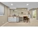 Stylish wet bar with a mini fridge, butcher block countertop, and decorative tile backsplash at 7064 E 2Nd Ave, Denver, CO 80220
