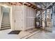Unfinished basement with visible utilities, access to the stairs and a solid white door at 821 Stony Mesa Pl, Castle Rock, CO 80108