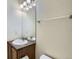 The bathroom has a sink with wood cabinets and a decorative vanity mirror and lighting at 821 Stony Mesa Pl, Castle Rock, CO 80108