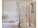 Bathroom with a large tub and a glass-enclosed shower at 821 Stony Mesa Pl, Castle Rock, CO 80108