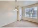 Well-lit dining room featuring neutral carpet, modern lighting, and natural light at 821 Stony Mesa Pl, Castle Rock, CO 80108