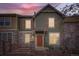 Inviting two-story townhome featuring a stone facade, wood accents, and a cozy front porch at 821 Stony Mesa Pl, Castle Rock, CO 80108