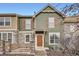 Inviting two-story townhome featuring a stone facade, wood accents, and a cozy front porch at 821 Stony Mesa Pl, Castle Rock, CO 80108