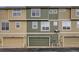 View of a three-unit townhouse exterior with attached garages, various colors and shared driveway at 821 Stony Mesa Pl, Castle Rock, CO 80108